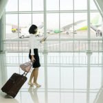 095701284 woman walks airport while usin 1 1 150x150